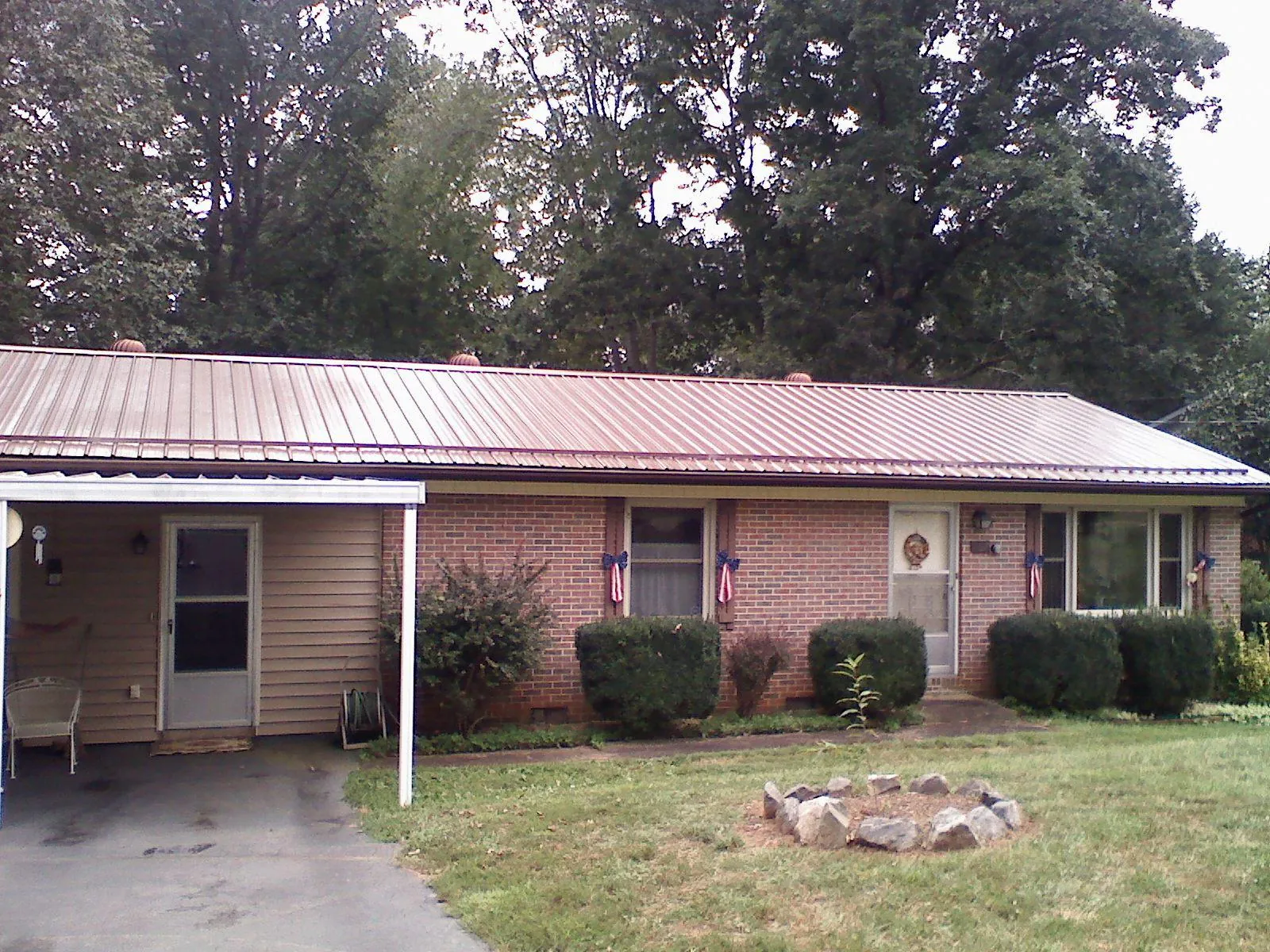 Bronze metal roof and carport on a brick ranch home — Roof Repair work by our crew in Auburn Hills